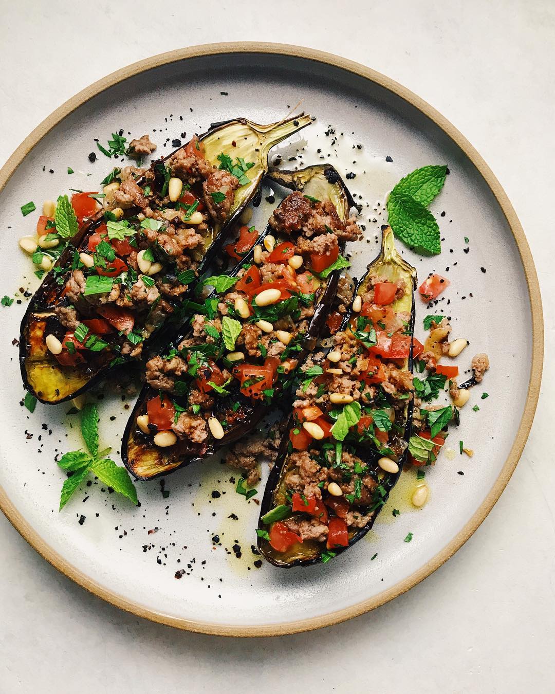 Broiled eggplants topped with crispy browned lamb, shallot, garlic, a super juic…